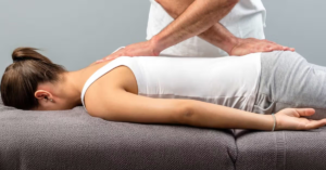 Chiropractor explaining the connection between spinal alignment and joint pain throughout the body