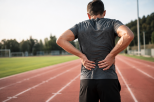 Athlete Pausing With Lower Back Pain